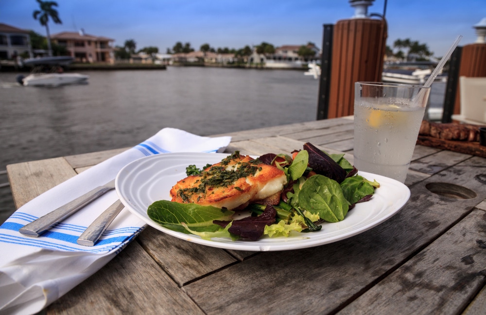 Enjoy the best places to eat in St. Augustine. Plate of seafood over looking water.